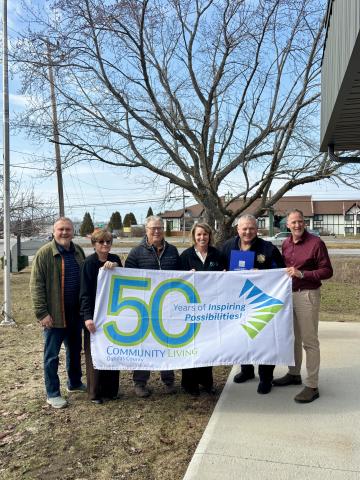 Community Living and Council holding flag